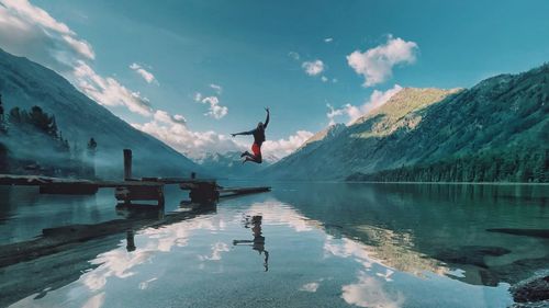 Scenic view of lake and mountains against sky