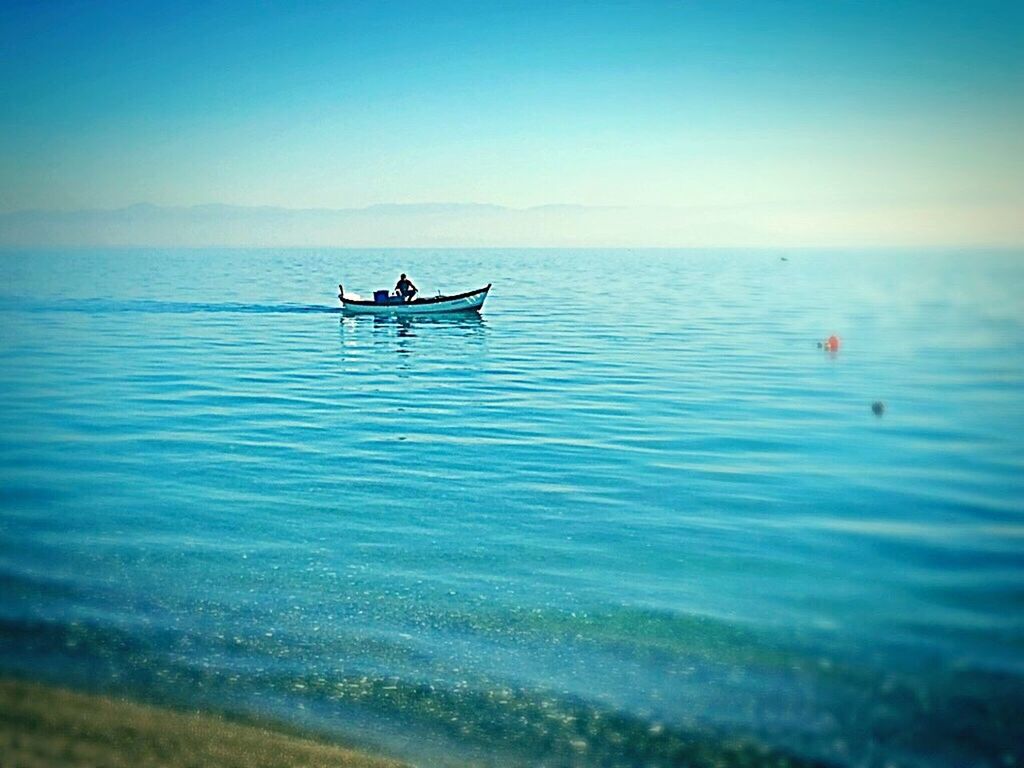 sea, nature, nautical vessel, beauty in nature, water, outdoors, real people, scenics, lifestyles, day, tranquility, tranquil scene, mode of transport, transportation, clear sky, adventure, sky, horizon over water, men, one person, people