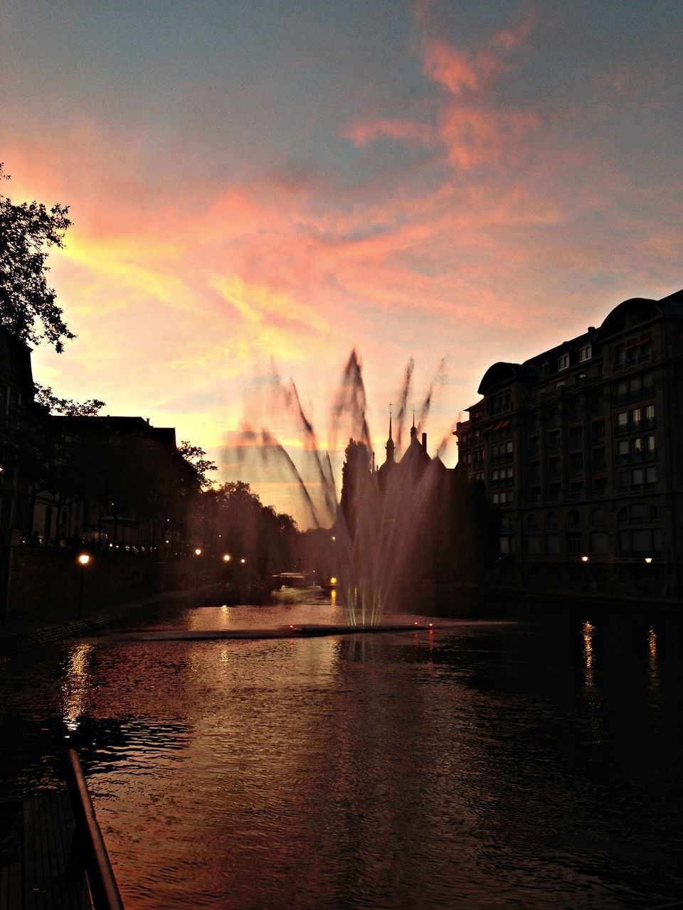 building exterior, architecture, built structure, water, sunset, sky, city, cloud - sky, waterfront, river, residential building, residential structure, dusk, illuminated, reflection, building, residential district, cityscape, silhouette, house