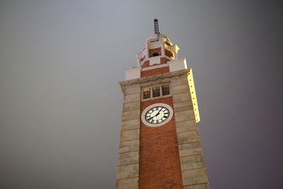 Low angle view of clock tower against building