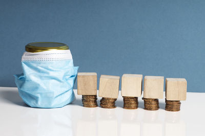 Close-up of coins on table against blue background