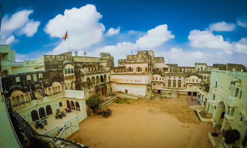 High angle view of buildings against cloudy sky