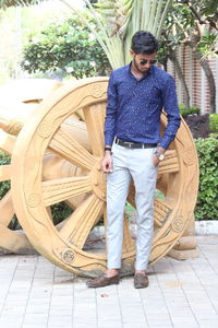 Young man standing on footpath in city