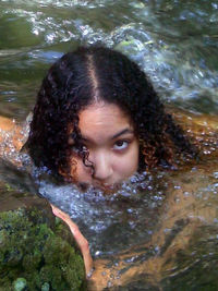 Portrait of young woman in water