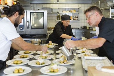 People working in restaurant kitchen