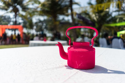 Pink teapot on table at outdoor cafe