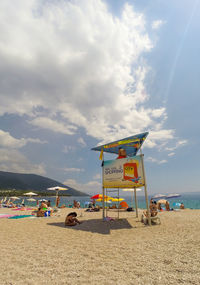 Lifeguard hut on beach against sky