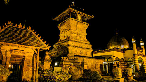 Low angle view of illuminated building against sky at night