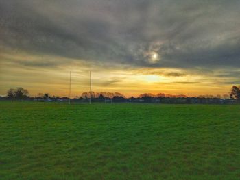 Scenic view of field against sky during sunset