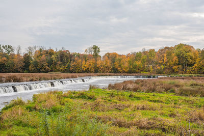 Scenic view of river against sky during autumn