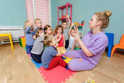 Rear view of people sitting on floor