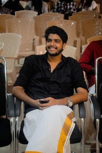Portrait of a smiling young man sitting on chair