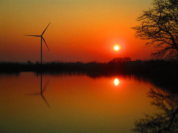 Scenic view of lake against romantic sky at sunset