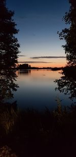 Scenic view of lake against sky at sunset