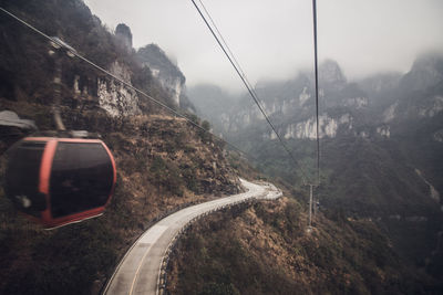 Road by mountains against sky