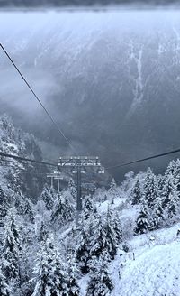 Overhead cable car over snowcapped mountains during winter