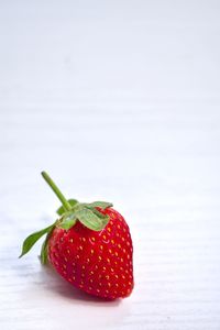 Close-up of strawberries on table against white background