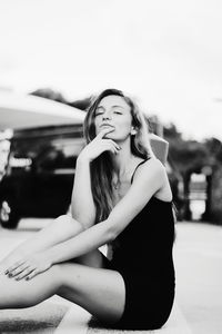 Portrait of a young woman sitting outdoors