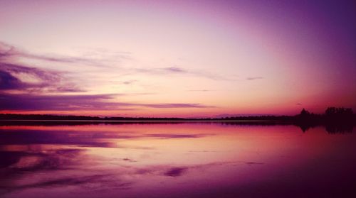 Scenic view of lake against romantic sky at sunset