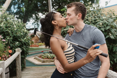 Young couple kissing in park