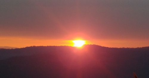 Scenic view of silhouette mountain against sky during sunset