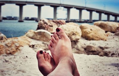 Low section of woman legs on beach