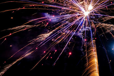 Low angle view of firework display at night