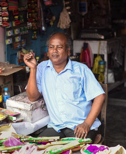 Portrait of smiling man sitting at table