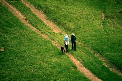 Man and woman walking on field