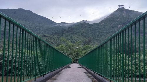 Railroad tracks leading towards mountains