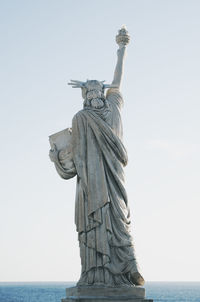 Low angle view of statue against sky