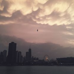 View of cityscape against cloudy sky