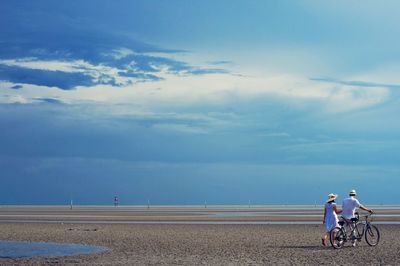 Silhouette of woman against cloudy sky