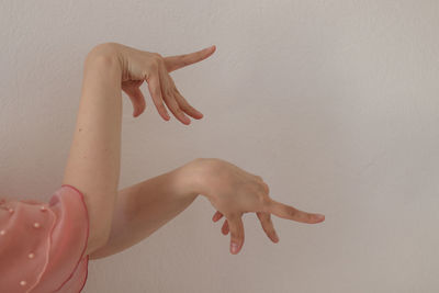 Low section of woman against red wall