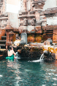 People sitting in front of temple