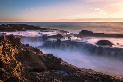 Scenic view of sea against sky at sunset