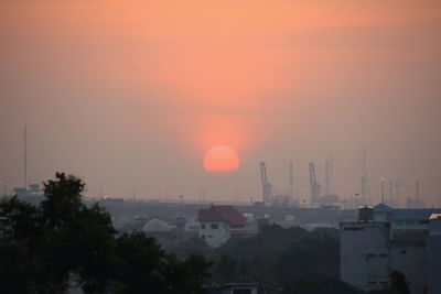 View of factory against sky during sunset