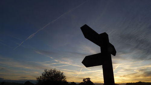 Low angle view of silhouette cross against sky during sunset