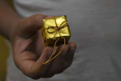 Close-up of hand holding candle