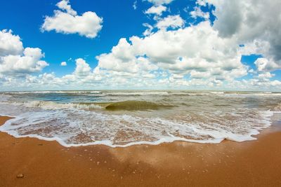 View of blue sea against cloudy sky