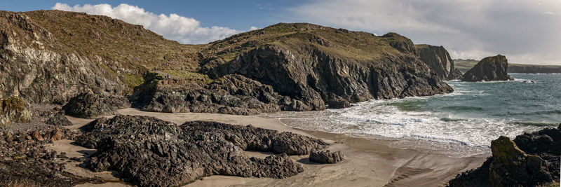 Scenic view of sea and mountains against sky