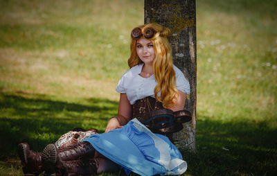 Young woman sitting on field