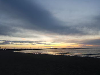 Scenic view of beach against sky during sunset