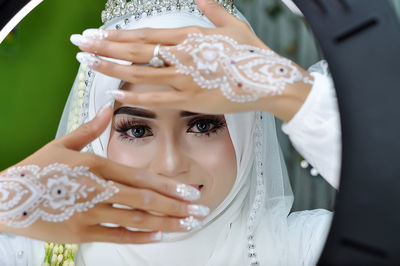 Bride posing looking at camera and wearing hijab