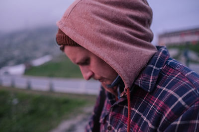 Young man in hood outdoors