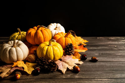 Close-up of pumpkin on table against black background