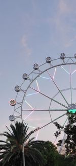 Low angle view of illuminated ferris wheel against sky