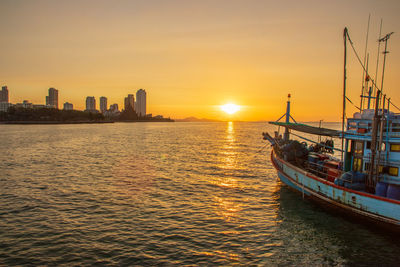 A fishing boat at the sea during the sunset timeline