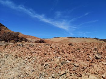 Scenic view of desert against blue sky