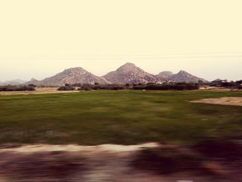 Scenic view of field against clear sky